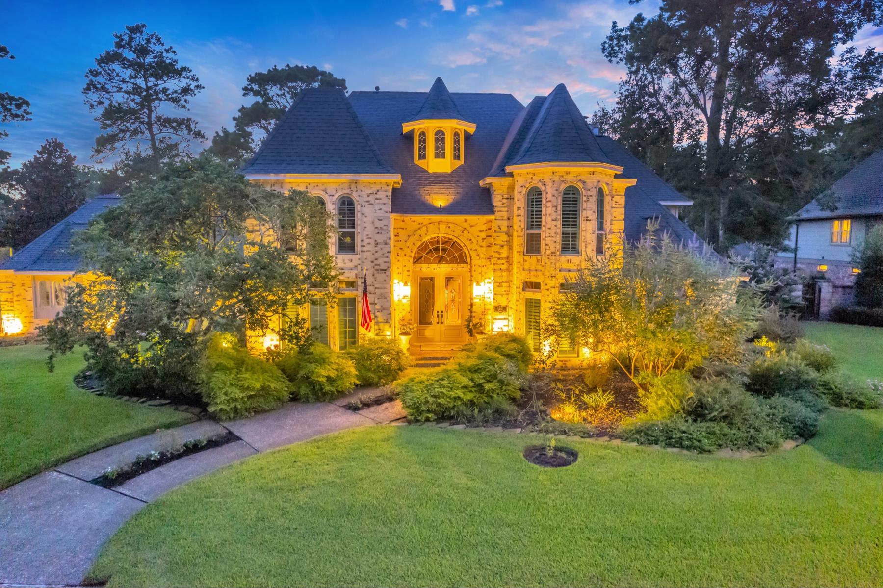 Stone home at twilight with every window lit