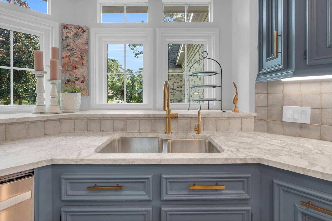 Kitchen detail with brass fixtures and a garden window